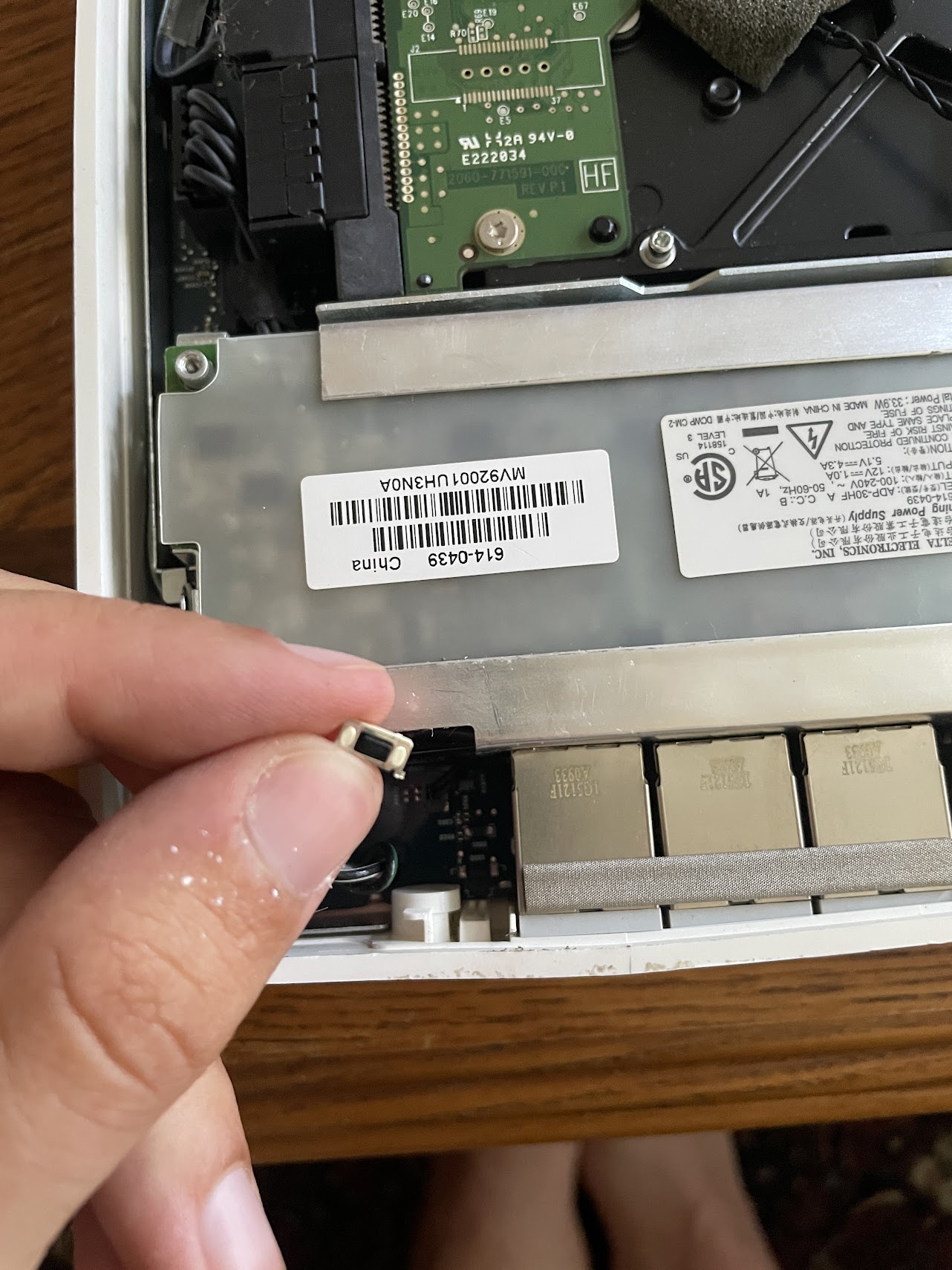 I hold this rice-grain sized reset switch in my fingers